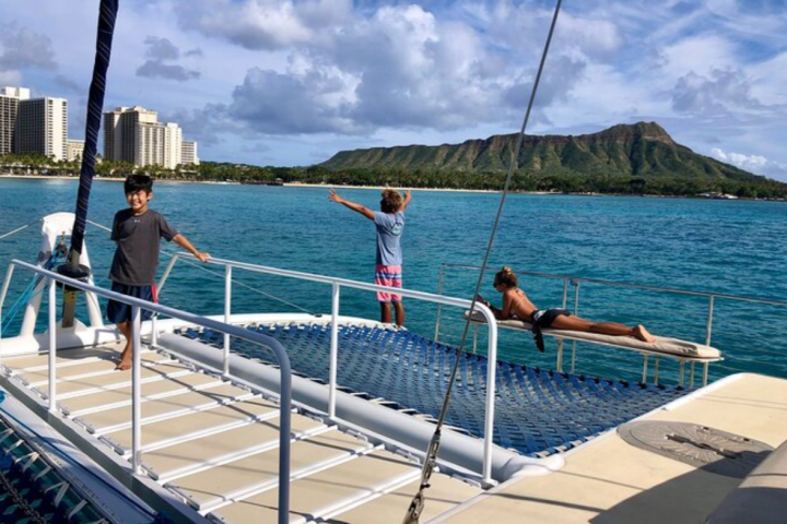 a group of people on a dock next to a body of water